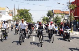Gandeng Penyintas Covid-19, Khofifah Bersepeda hingga Bagikan Masker