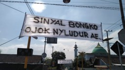 Spanduk 'Pedes' Terpasang di Perlintasan Kereta Api Morojantek, Malang